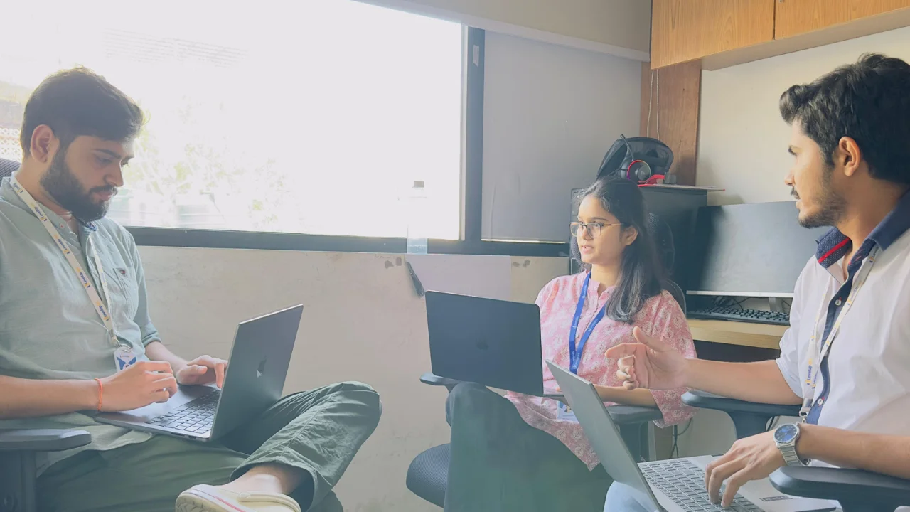 Colleagues collaborating with laptops in the office